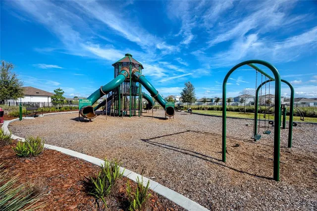 a childrens park with lots of swings and slides