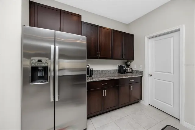 a kitchen with a refrigerator and a sink