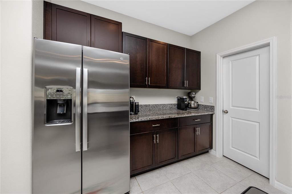 16654 Carlton Pond Street Wimauma, FL 33598 - Photo 10 of 48 a kitchen with a refrigerator and a sink