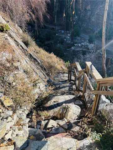 a view of outdoor space with wooden floor and trees