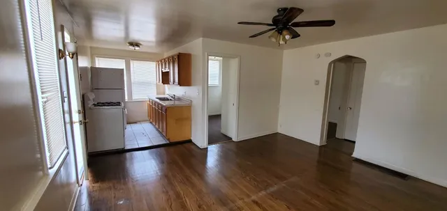 a view of a hallway view with wooden floor and a cabinet