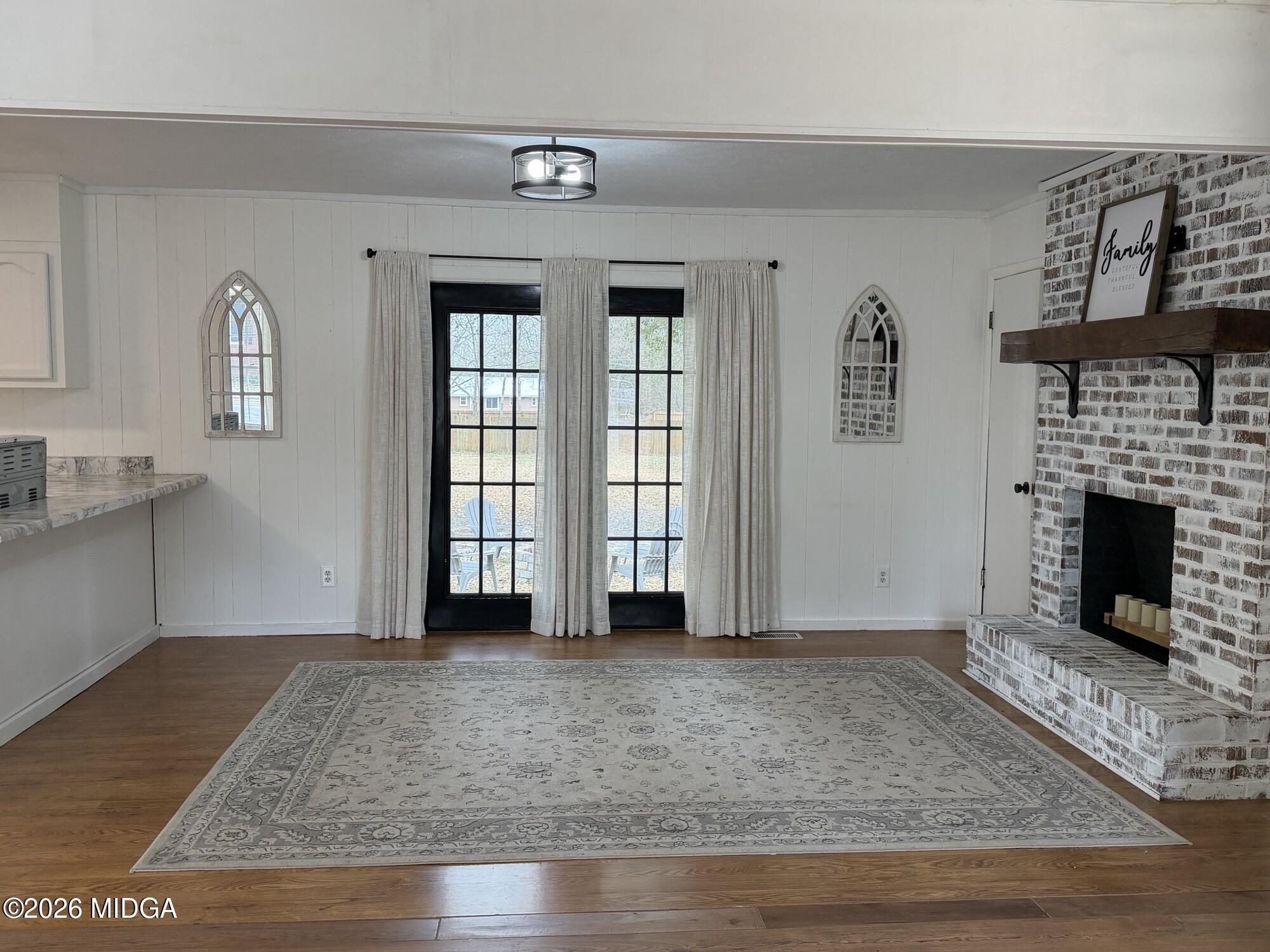 229 Southwest Peter Street Cochran, GA 31014 - Photo 11 of 24 a view of an empty room with window and fireplace