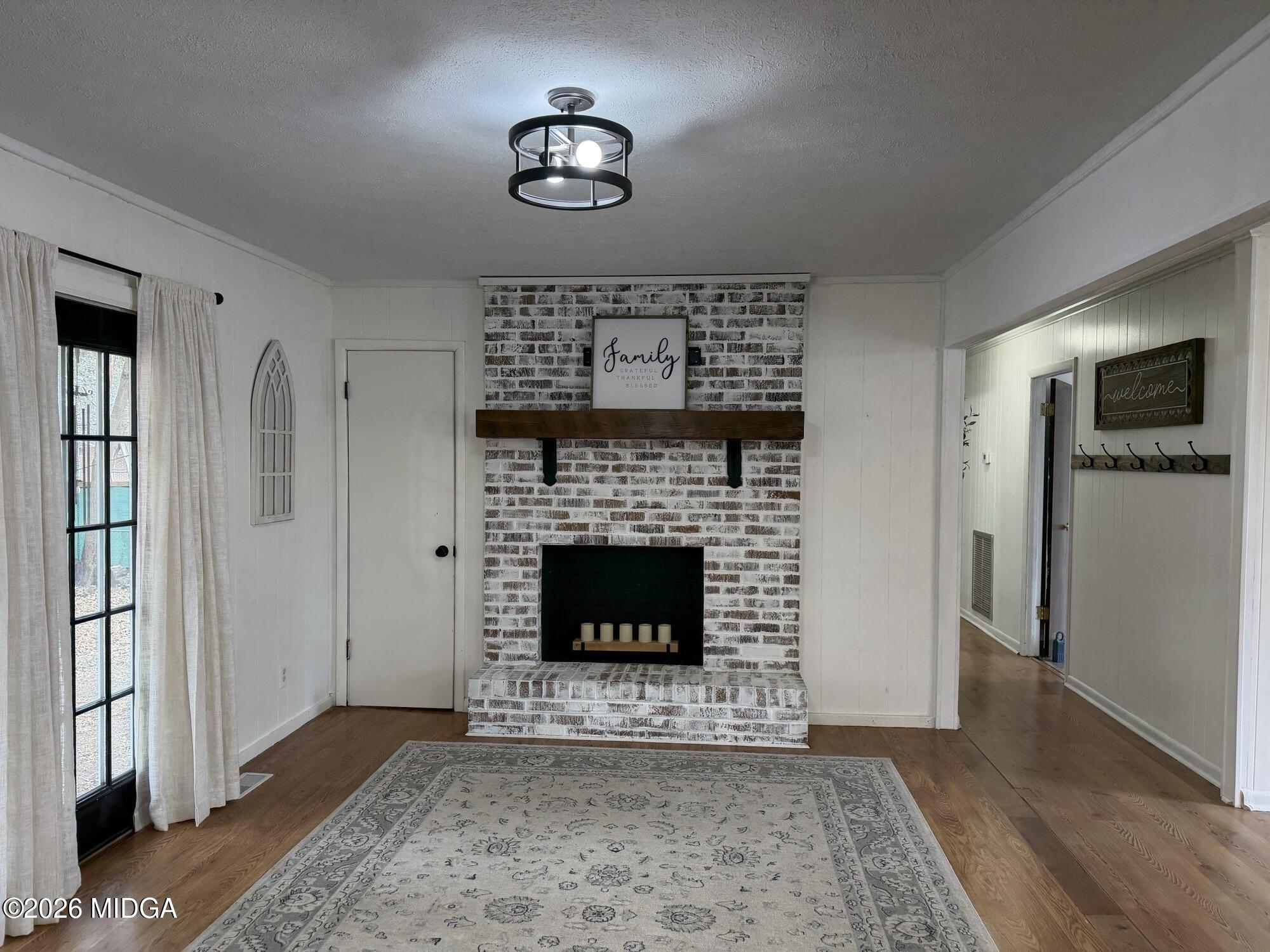 229 Southwest Peter Street Cochran, GA 31014 - Photo 12 of 24 a living room with furniture and a fireplace