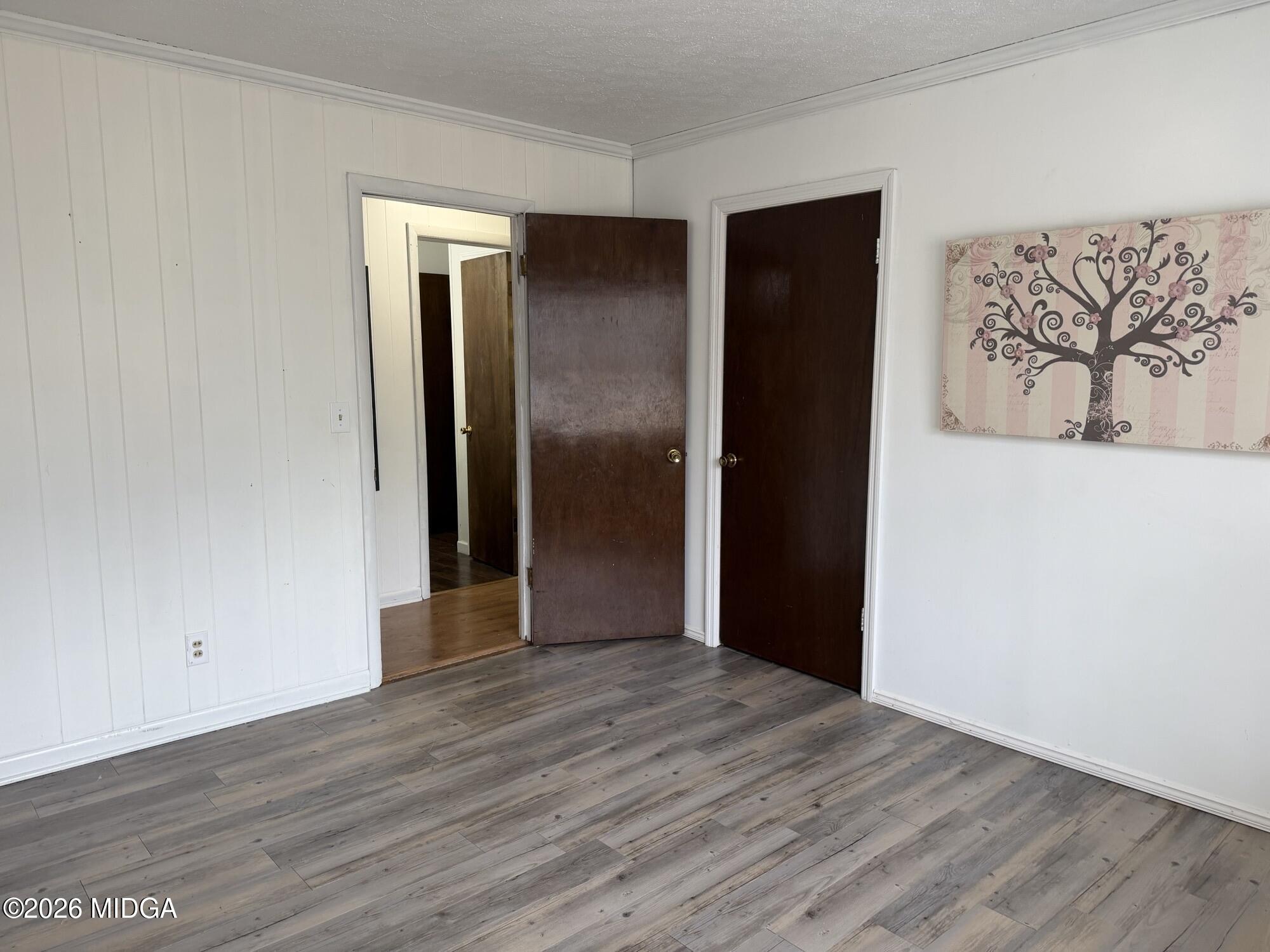 229 Southwest Peter Street Cochran, GA 31014 - Photo 15 of 24 a view of an empty room with wooden floor