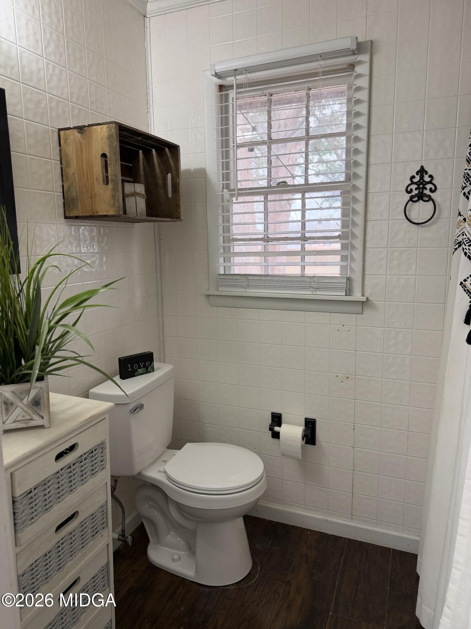 229 Southwest Peter Street Cochran, GA 31014 - Photo 17 of 24 a white toilet sitting next to a bathroom sink
