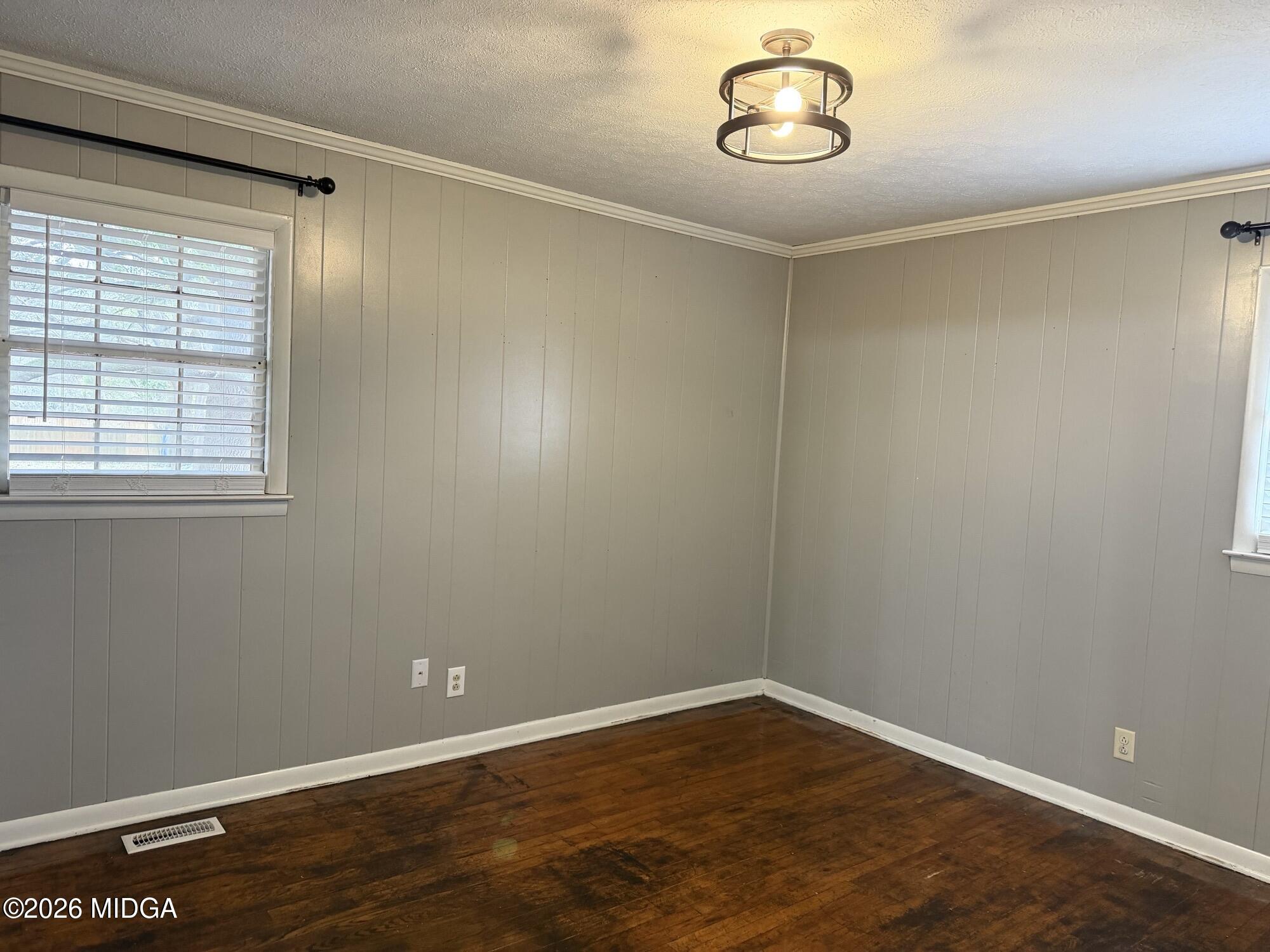 229 Southwest Peter Street Cochran, GA 31014 - Photo 18 of 24 an empty room with wooden floor and windows