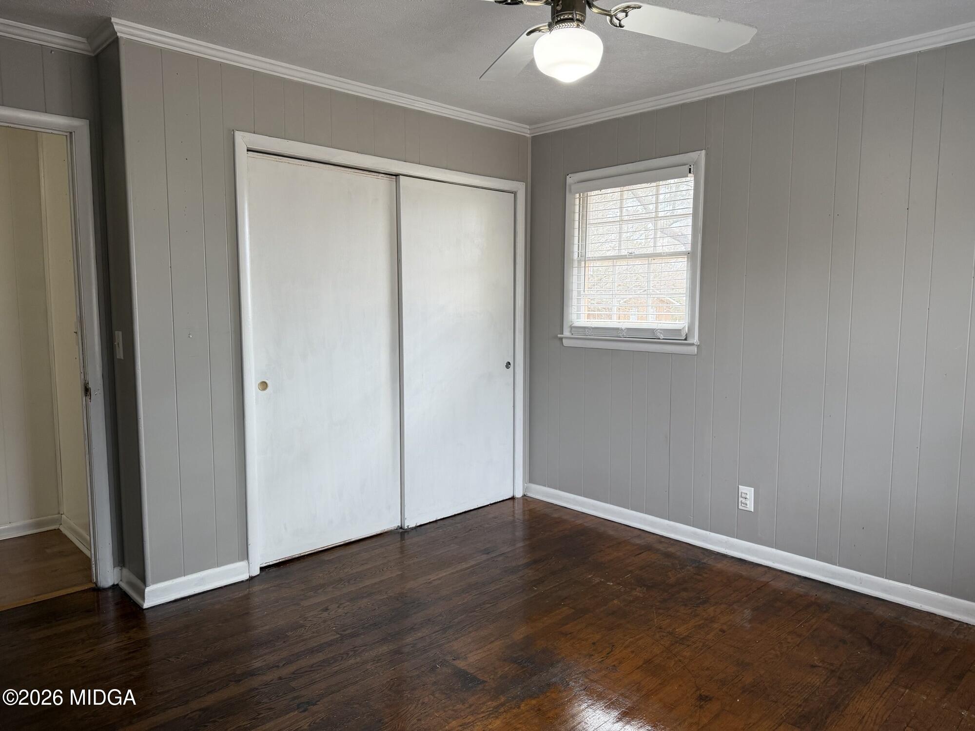 229 Southwest Peter Street Cochran, GA 31014 - Photo 21 of 24 a view of an empty room with wooden floor and a window