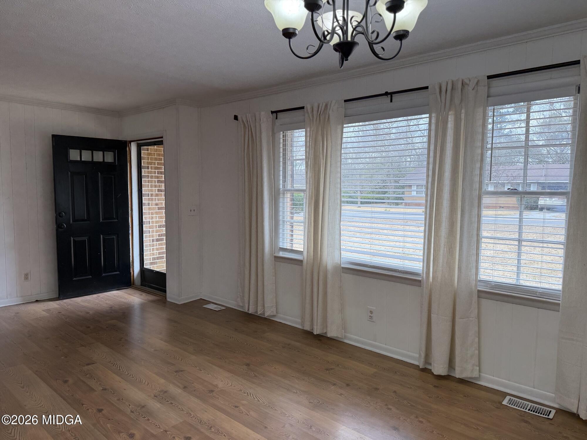 229 Southwest Peter Street Cochran, GA 31014 - Photo 3 of 24 a view of a livingroom with a chandelier fan and windows