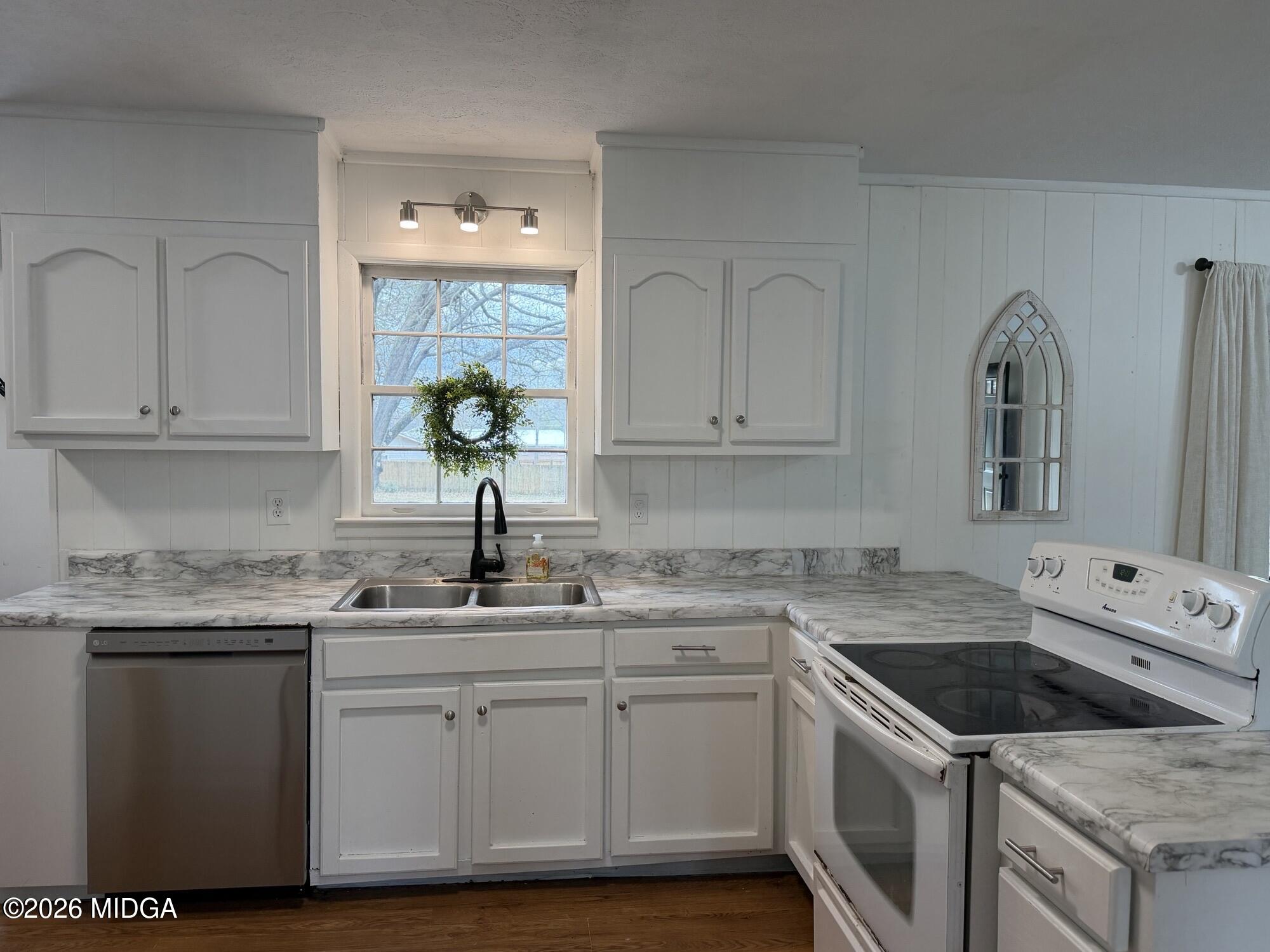 229 Southwest Peter Street Cochran, GA 31014 - Photo 6 of 24 a kitchen with white cabinets appliances and a sink