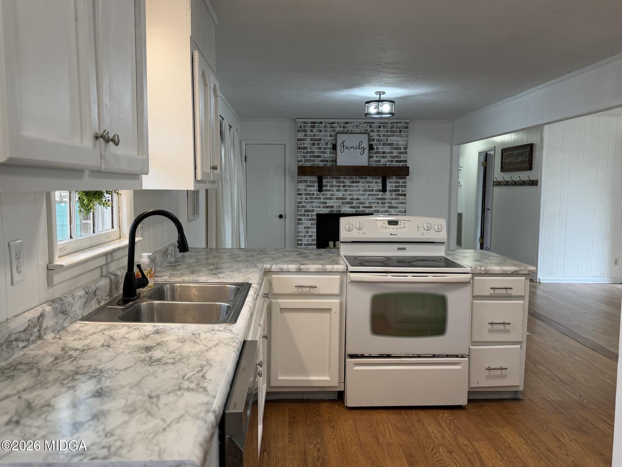 229 Southwest Peter Street Cochran, GA 31014 - Photo 7 of 24 a kitchen with a stove and a sink