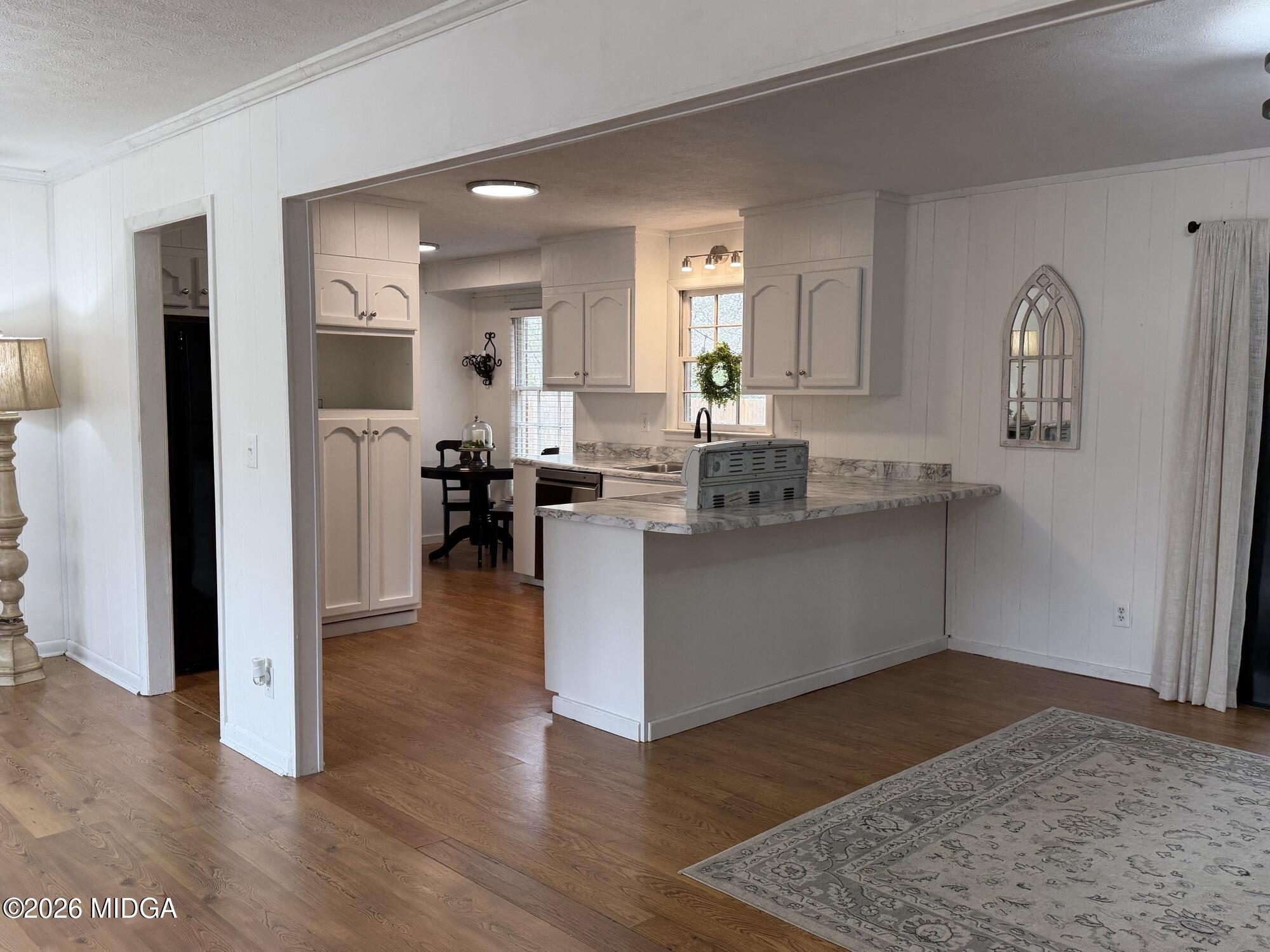 229 Southwest Peter Street Cochran, GA 31014 - Photo 8 of 24 a living room with stainless steel appliances granite countertop furniture wooden floor and a view of kitchen