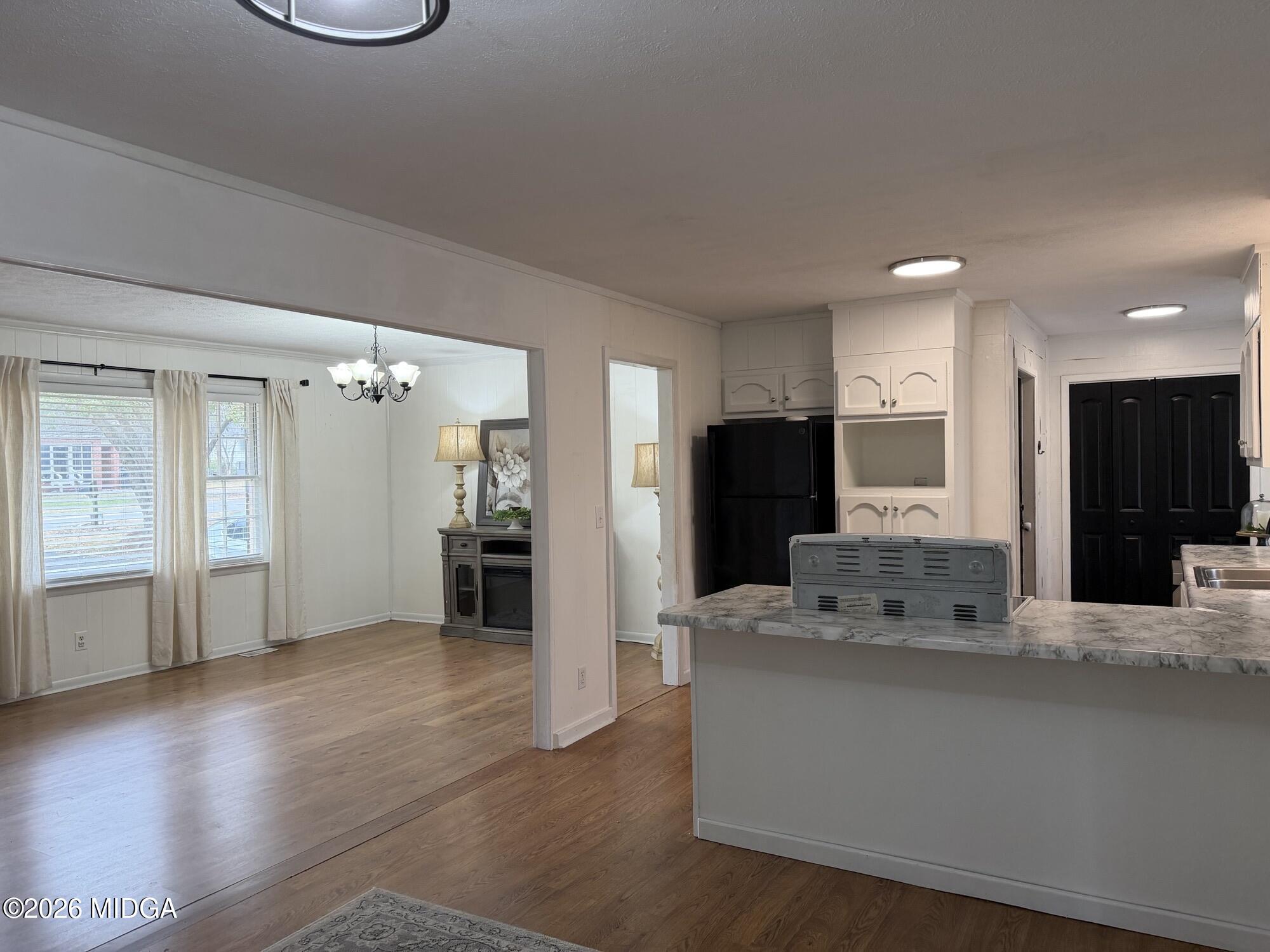 229 Southwest Peter Street Cochran, GA 31014 - Photo 9 of 24 a large white kitchen with a large window