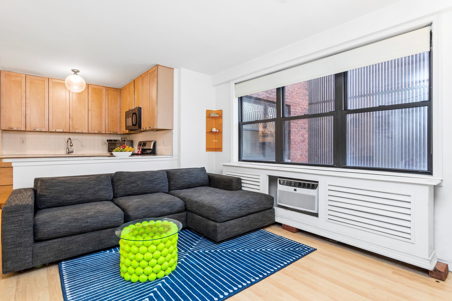 330 3rd Avenue, Unit 3L Manhattan, NY 10010 - Photo 3 of 13 a living room with furniture and a gate