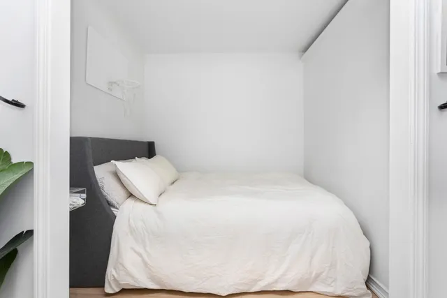 a white bed in a white room