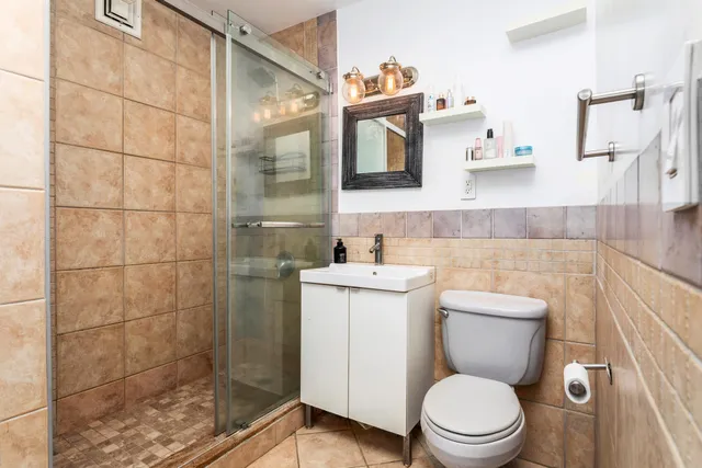 a bathroom with a toilet sink and shower