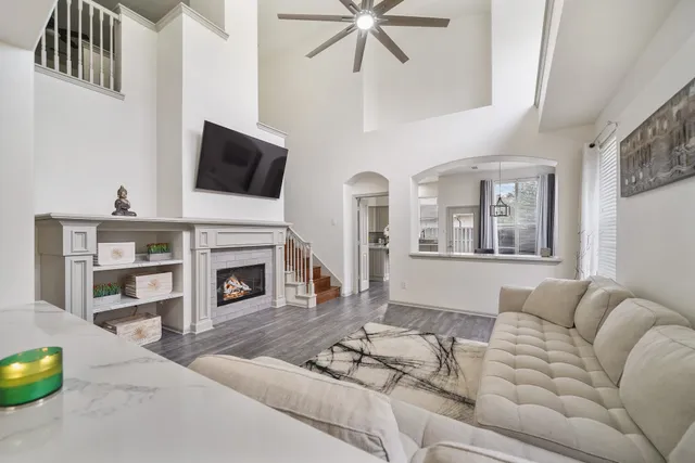 a living room with furniture a fireplace and a flat screen tv