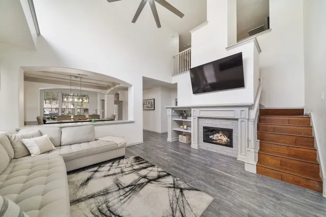 a living room with furniture a fireplace and a flat screen tv