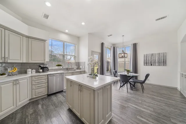 a kitchen with sink cabinets and wooden floor