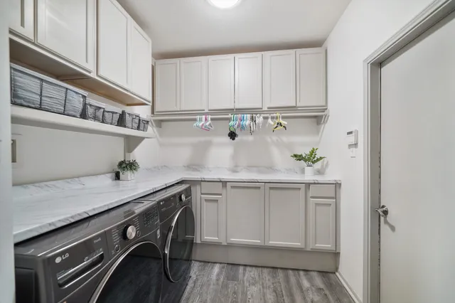 a kitchen with stainless steel appliances white cabinets and a sink