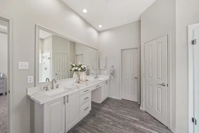 a spacious bathroom with a double vanity sink and mirror