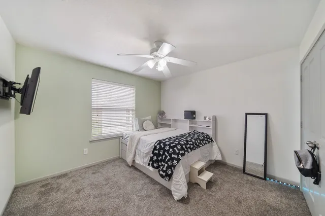 a bedroom with a bed and a chandelier