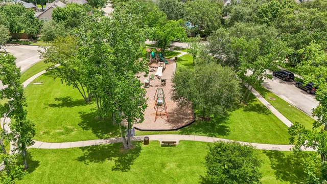 an aerial view of a house with a garden and swimming pool