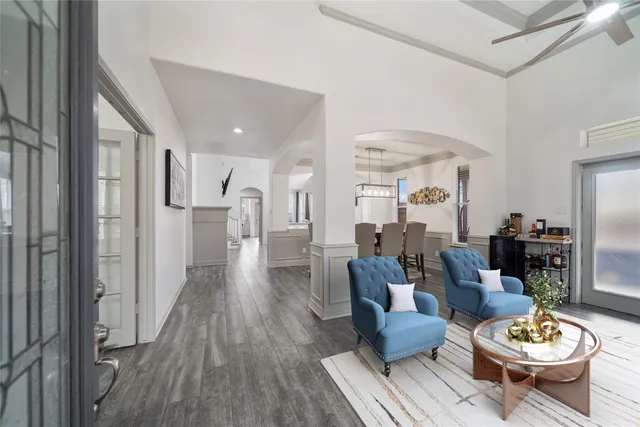 a living room with furniture and a wooden floor