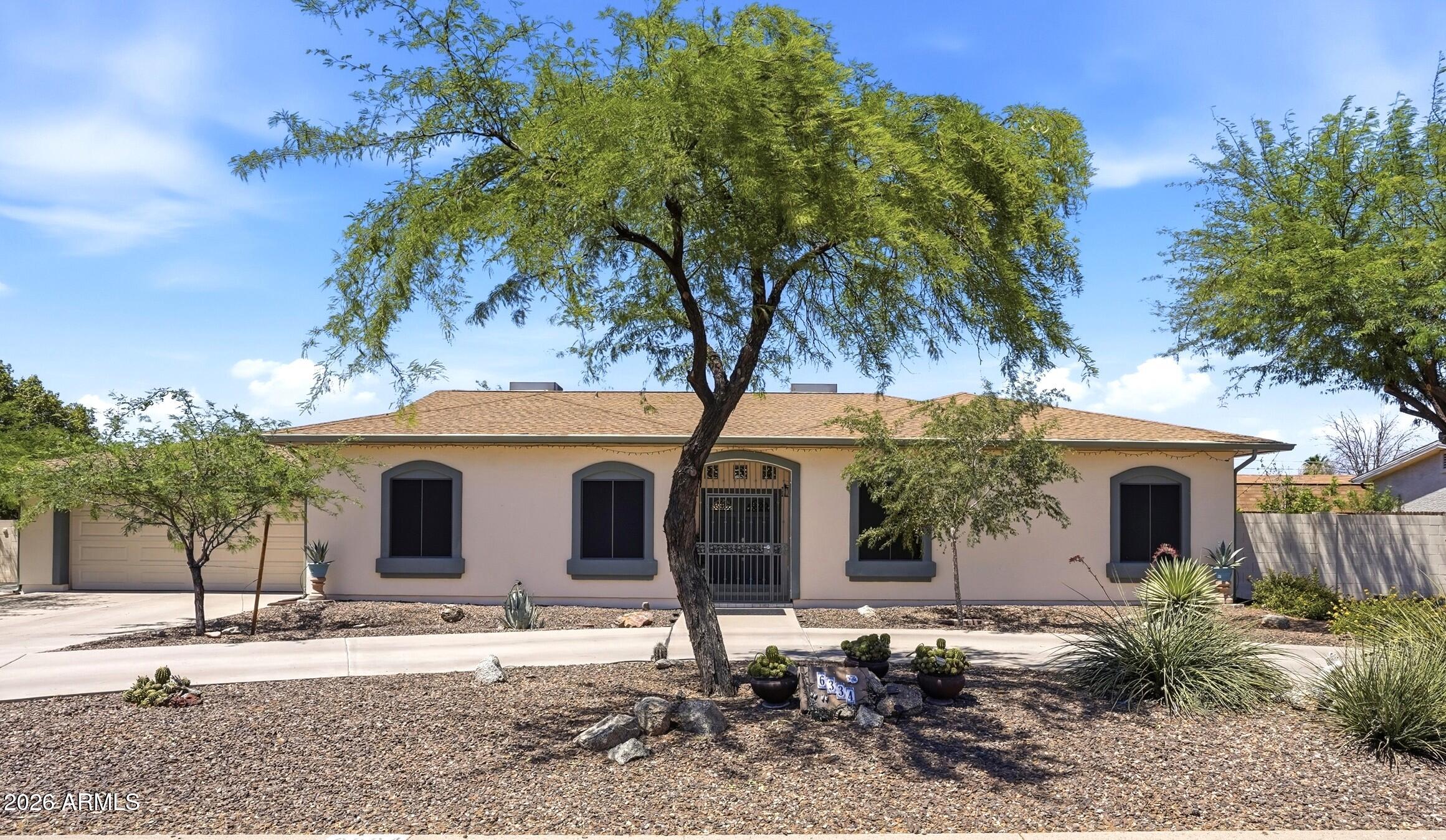 a view of a house with a yard and tree s