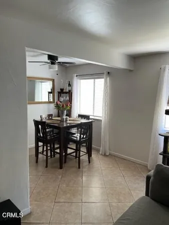 a view of a dining room with furniture and window