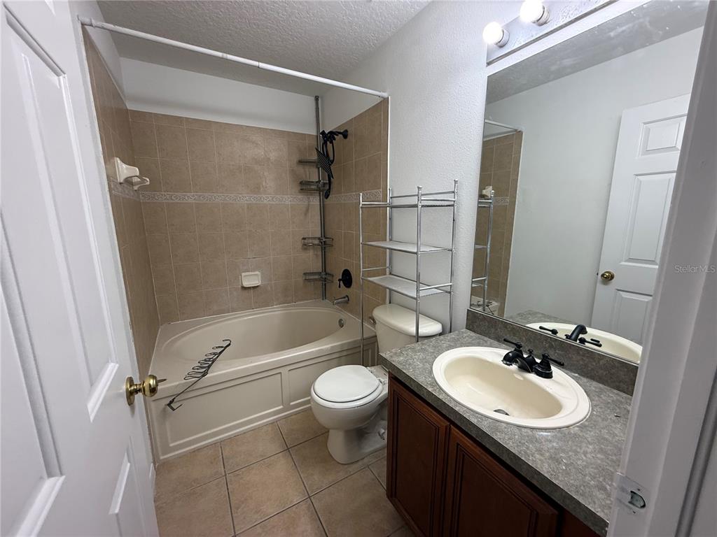 201 Drawbridge Lane Valrico, FL 33594 - Photo 11 of 11 a bathroom with a granite countertop sink toilet mirror and shower