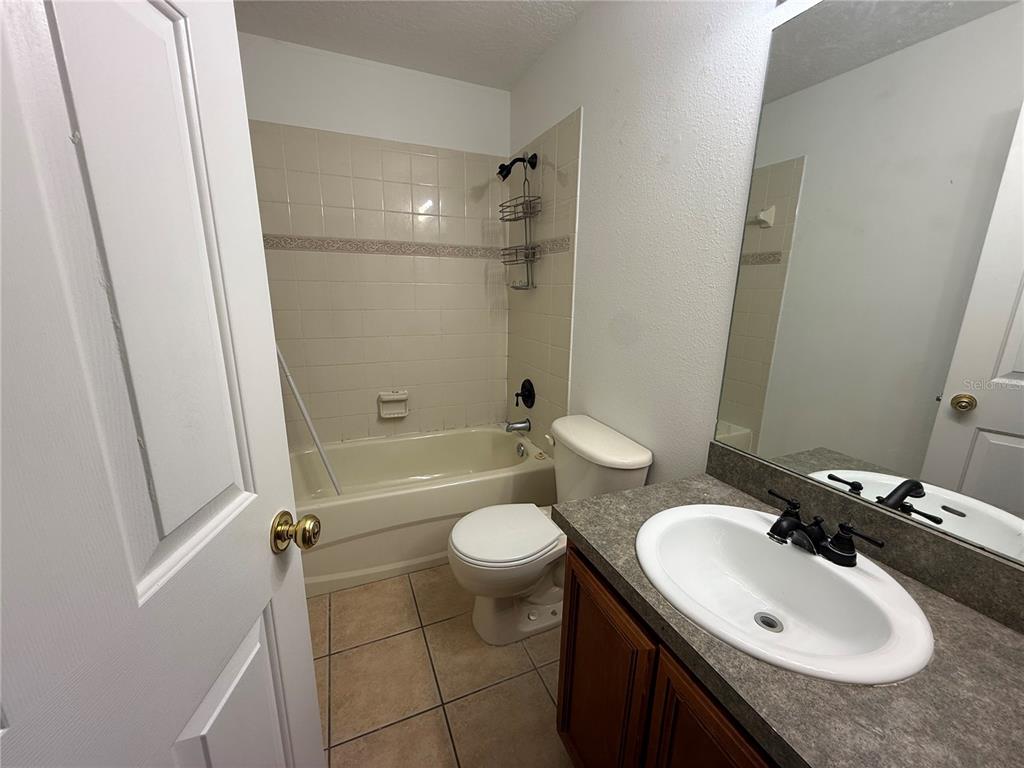 201 Drawbridge Lane Valrico, FL 33594 - Photo 7 of 11 a bathroom with a sink toilet mirror and shower