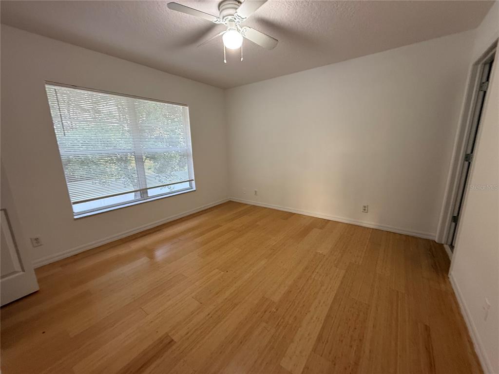 201 Drawbridge Lane Valrico, FL 33594 - Photo 9 of 11 a view of an empty room with wooden floor and a window