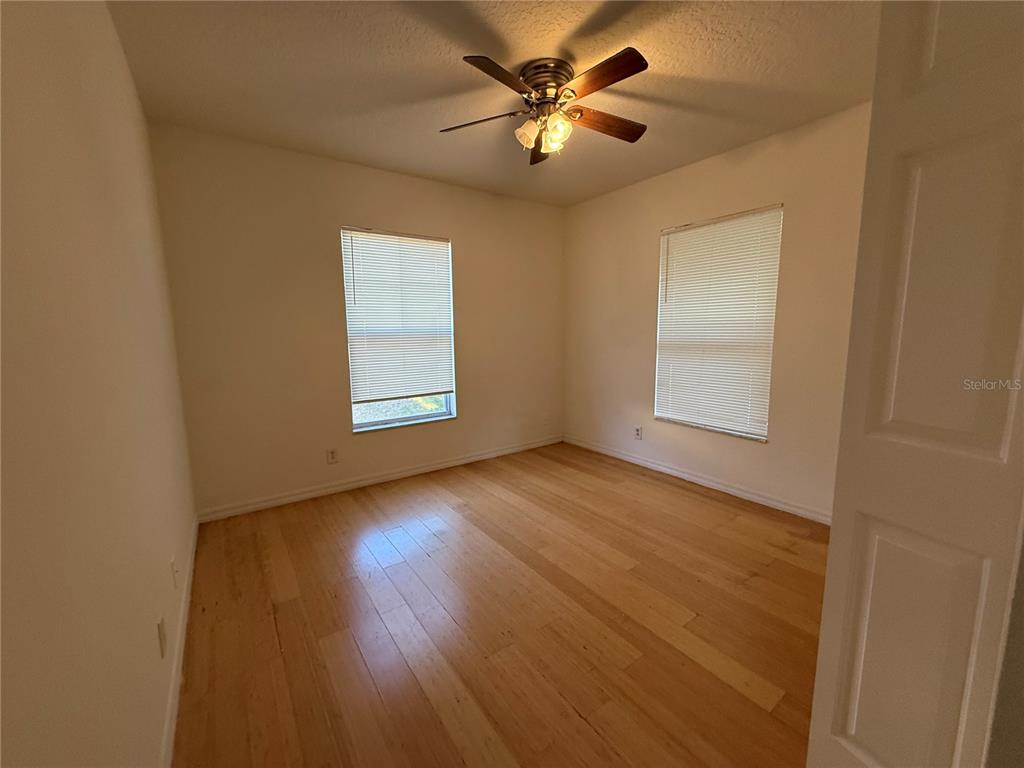 201 Drawbridge Lane Valrico, FL 33594 - Photo 10 of 11 an empty room with wooden floor and windows