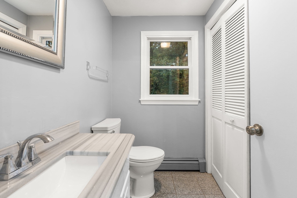 8 McDonald Road Wilmington, MA 01887 - Photo 13 of 40 a bathroom with a sink a toilet and a window