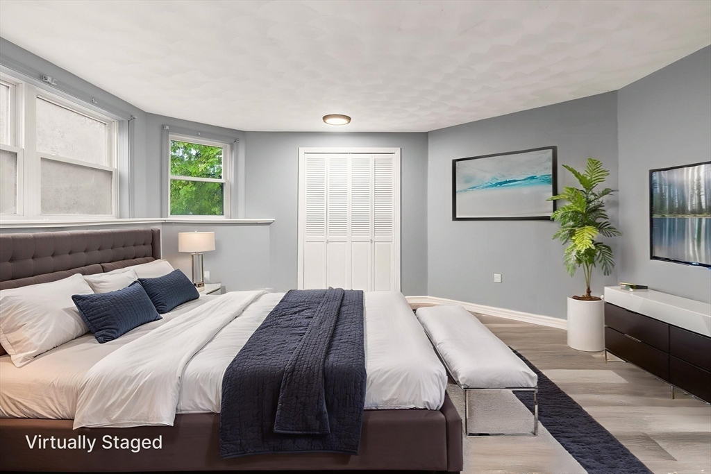 8 McDonald Road Wilmington, MA 01887 - Photo 25 of 40 a bedroom with a bed and a potted plant