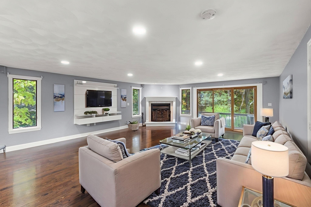 8 McDonald Road Wilmington, MA 01887 - Photo 3 of 40 a living room with furniture flat screen tv and a large window
