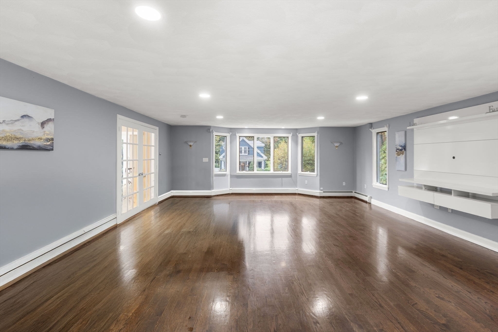 8 McDonald Road Wilmington, MA 01887 - Photo 5 of 40 a view of an empty room with wooden floor and a window