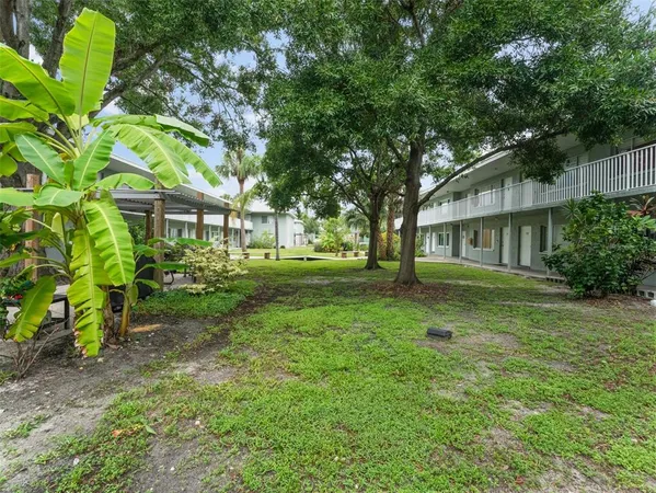 a kitchen with granite countertop white cabinets and stainless steel appliances
