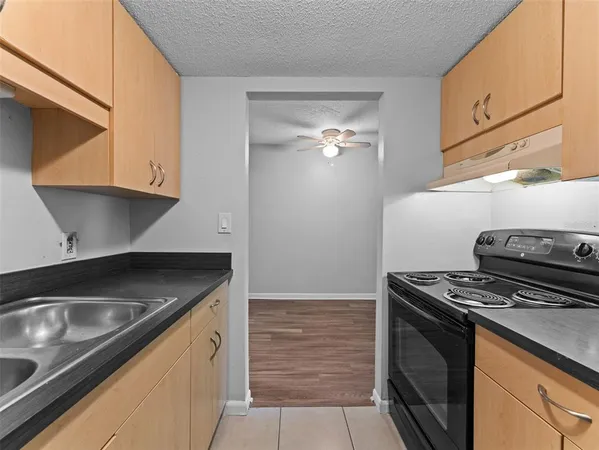 a kitchen with stainless steel appliances granite countertop a refrigerator and a stove