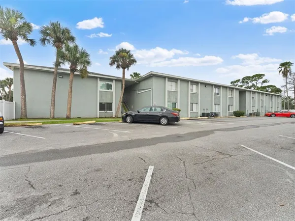 an aerial view of a house with swimming pool and furniture