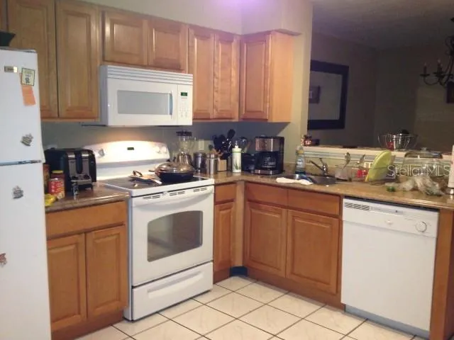 a kitchen with stainless steel appliances granite countertop a refrigerator a stove and a cabinets
