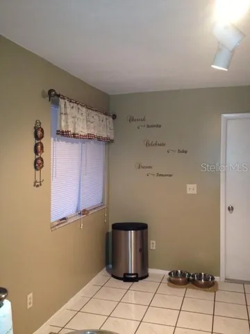 a room with a cabinet and a refrigerator