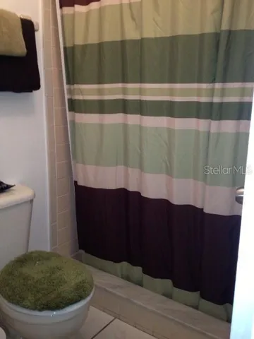 a bedroom with a bed and a lamp