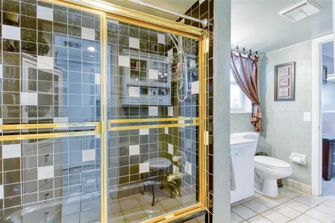 a bathroom with a toilet sink and shower