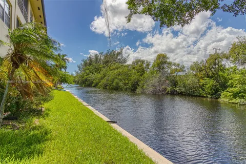 a view of a lake with a house in the background
