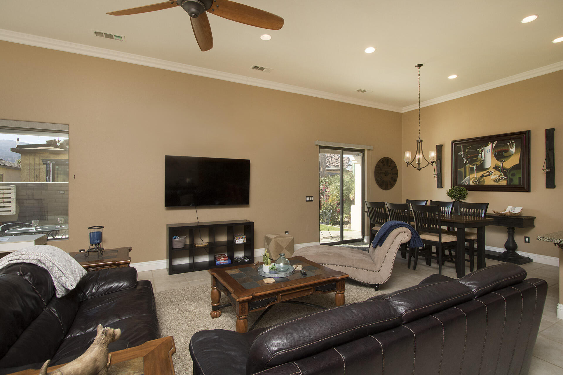 57669 Santa Rosa Trail La Quinta, CA 92253 - Photo 26 of 59 a living room with furniture a flat screen tv and kitchen view
