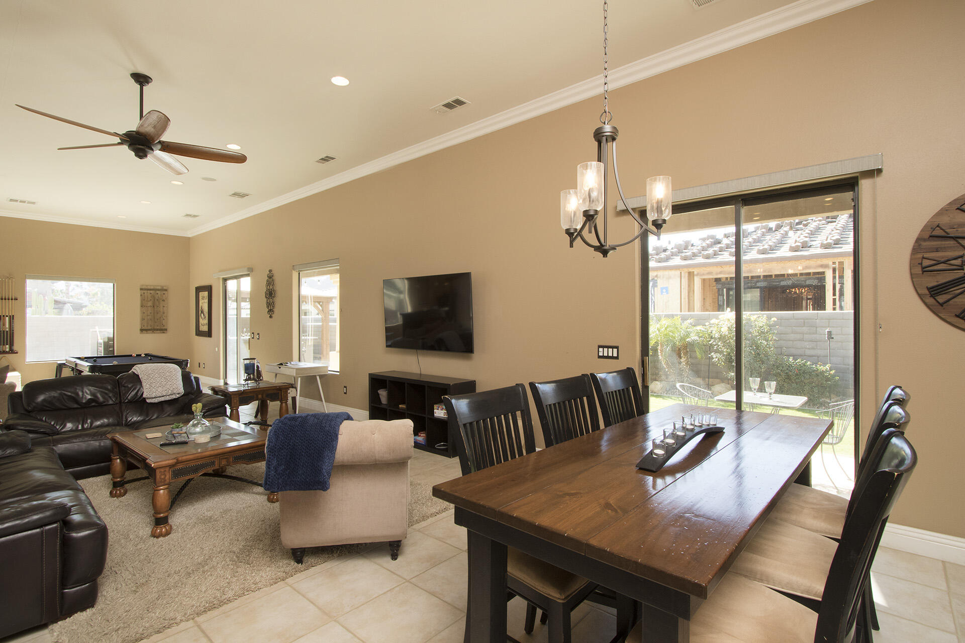 57669 Santa Rosa Trail La Quinta, CA 92253 - Photo 29 of 59 a living room with furniture a chandelier and a flat screen tv