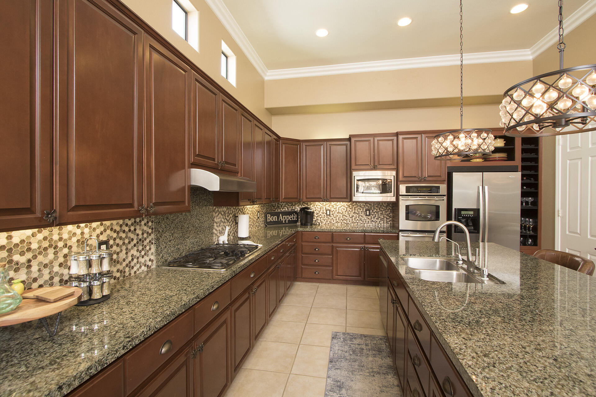 57669 Santa Rosa Trail La Quinta, CA 92253 - Photo 31 of 59 a large kitchen with granite countertop a sink and a counter top space
