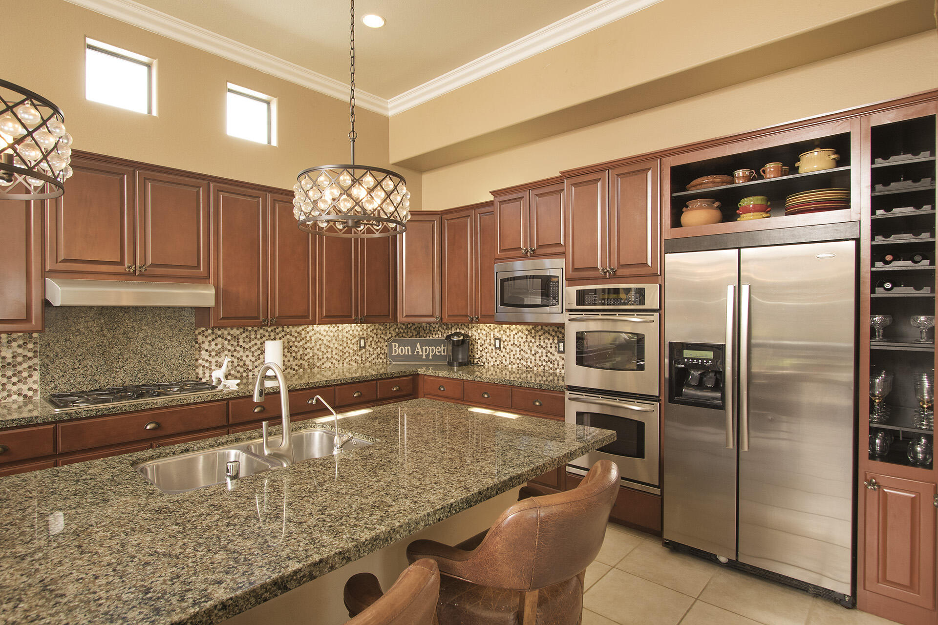 57669 Santa Rosa Trail La Quinta, CA 92253 - Photo 32 of 59 a kitchen with stainless steel appliances granite countertop a sink refrigerator and cabinets