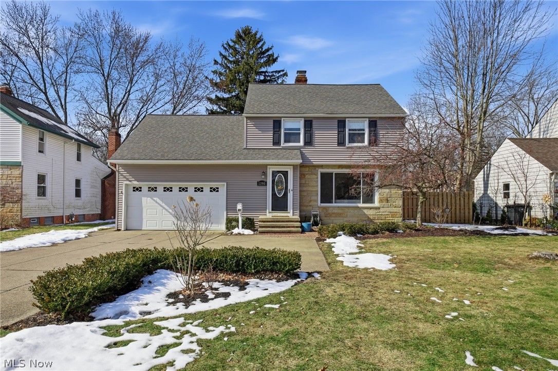 View of front of house with a garage, driveway, a chimney, stone siding, and a shingled roof